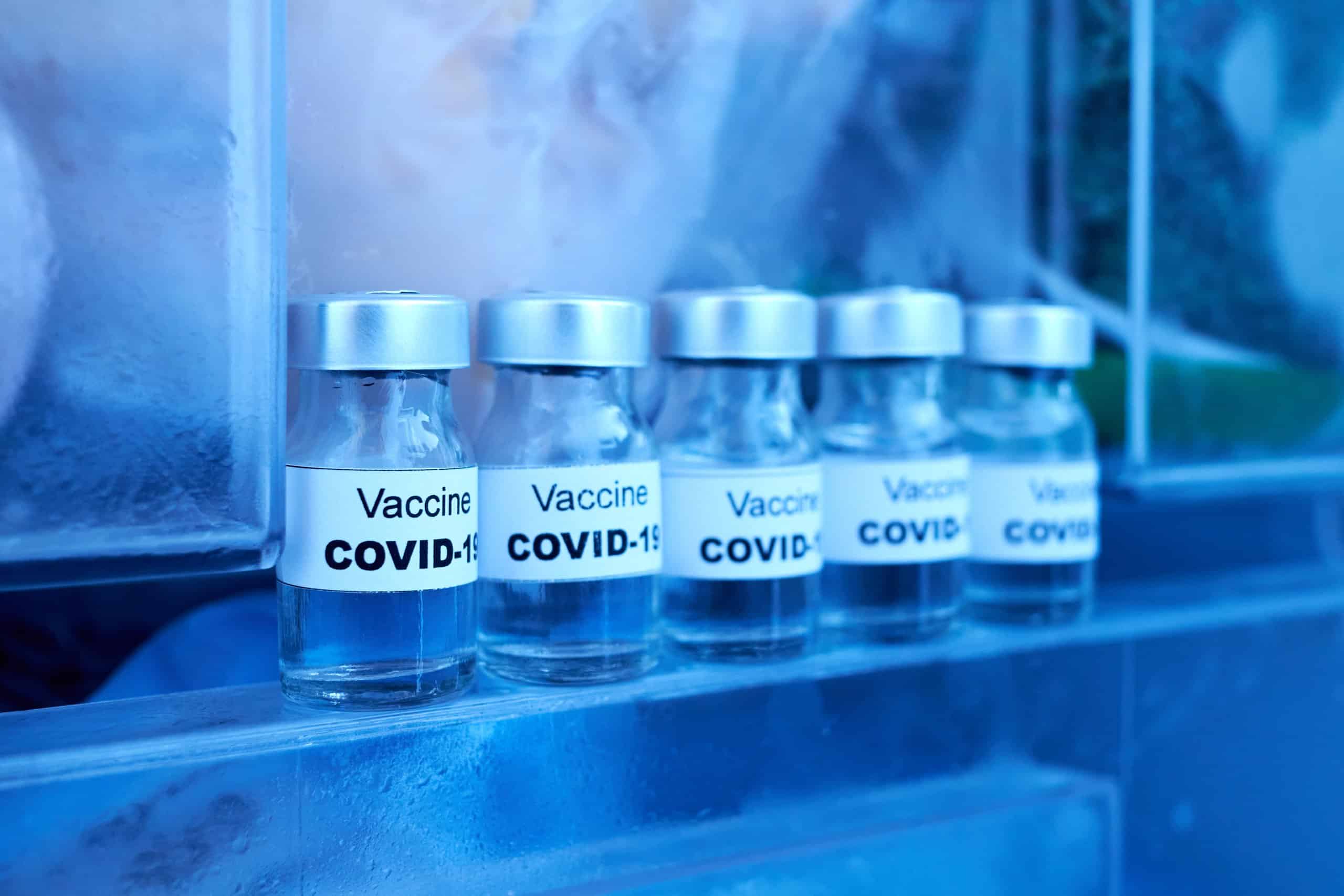several covid-19 vaccine vials in a medical freezer
